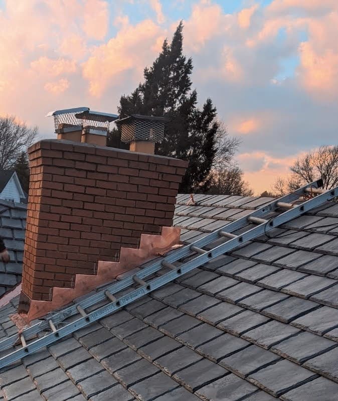 Chimney repair at sunset